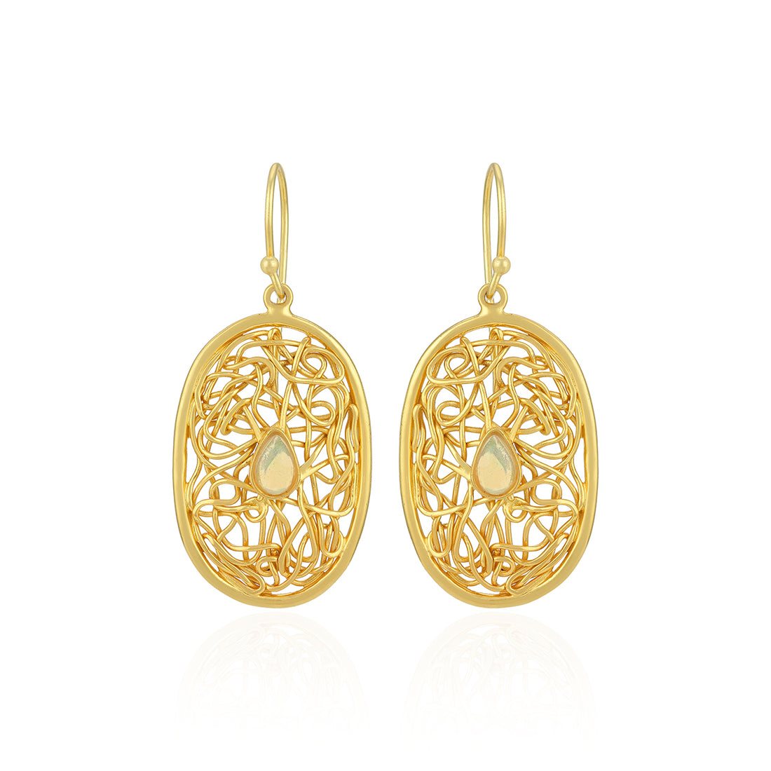 Gold filigree earrings with teardrop-shaped centers on a white background
