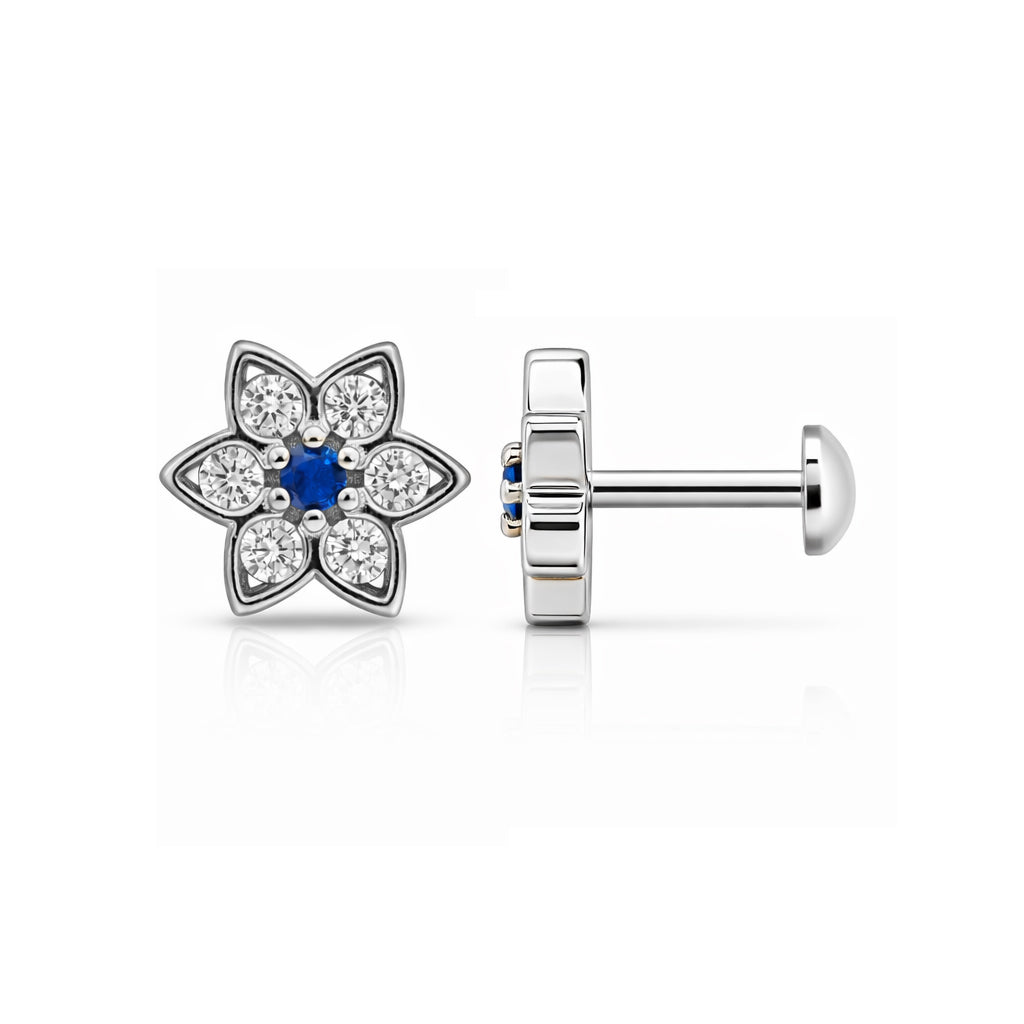 Flower-shaped earring with blue center and clear stones on a white background