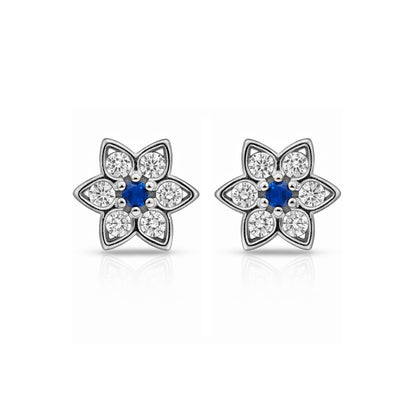 Flower-shaped earrings with blue centers and clear gemstones on a white background