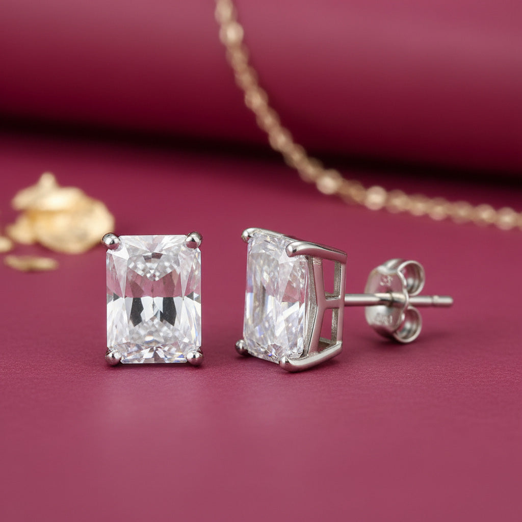 Diamond stud earrings on a red background