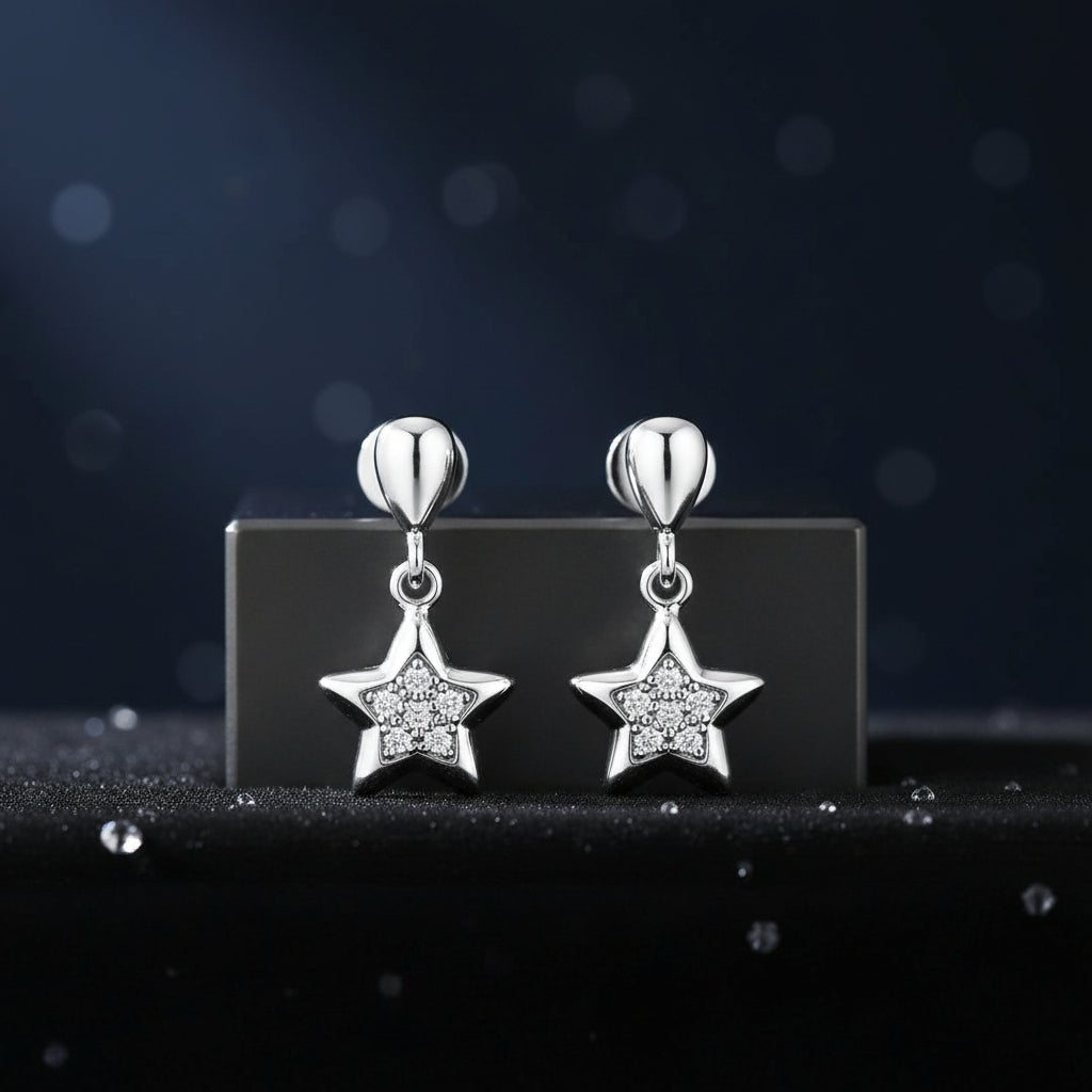 Silver star-shaped earrings on a dark background