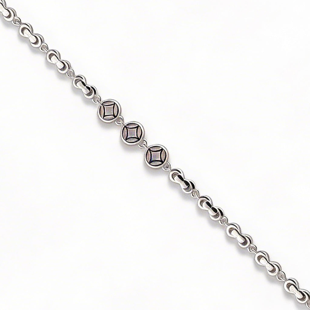 Silver bracelet with diamond-like beads on a white background