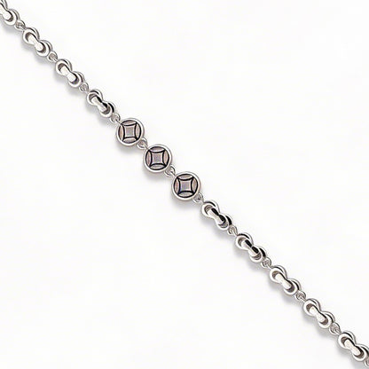 Silver bracelet with diamond-like beads on a white background