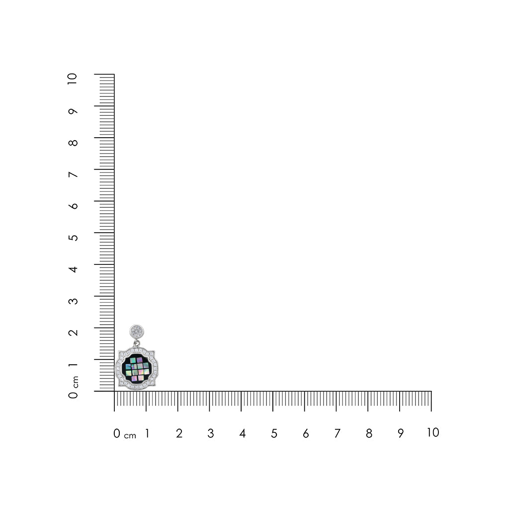 Small round pendant with colorful design on a ruler for scale