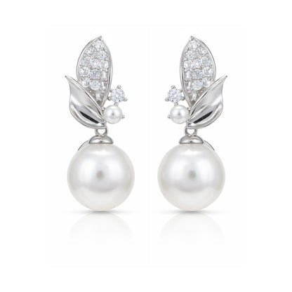 Pair of pearl earrings with diamond accents on a white background