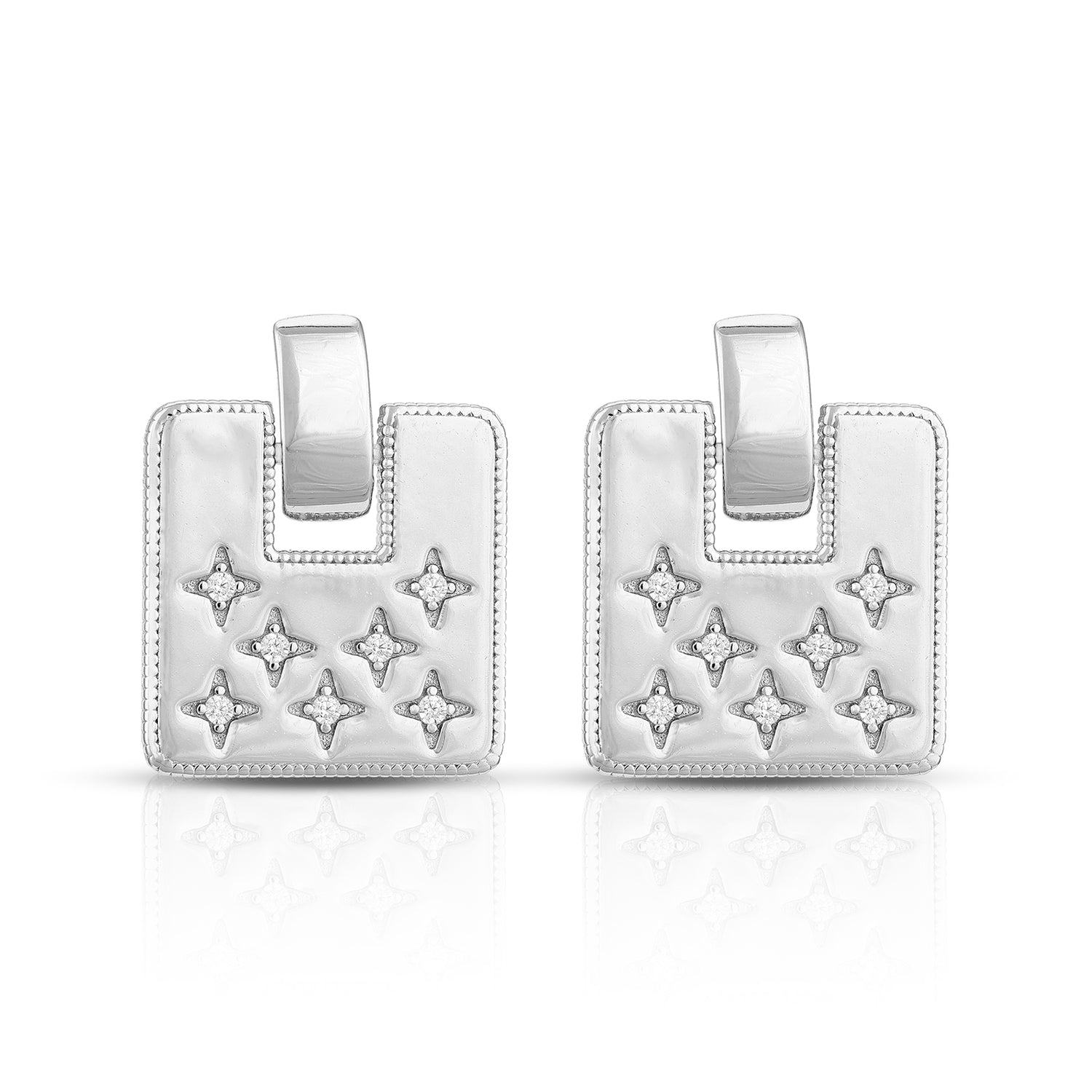 Pair of silver earrings with star designs on a white background