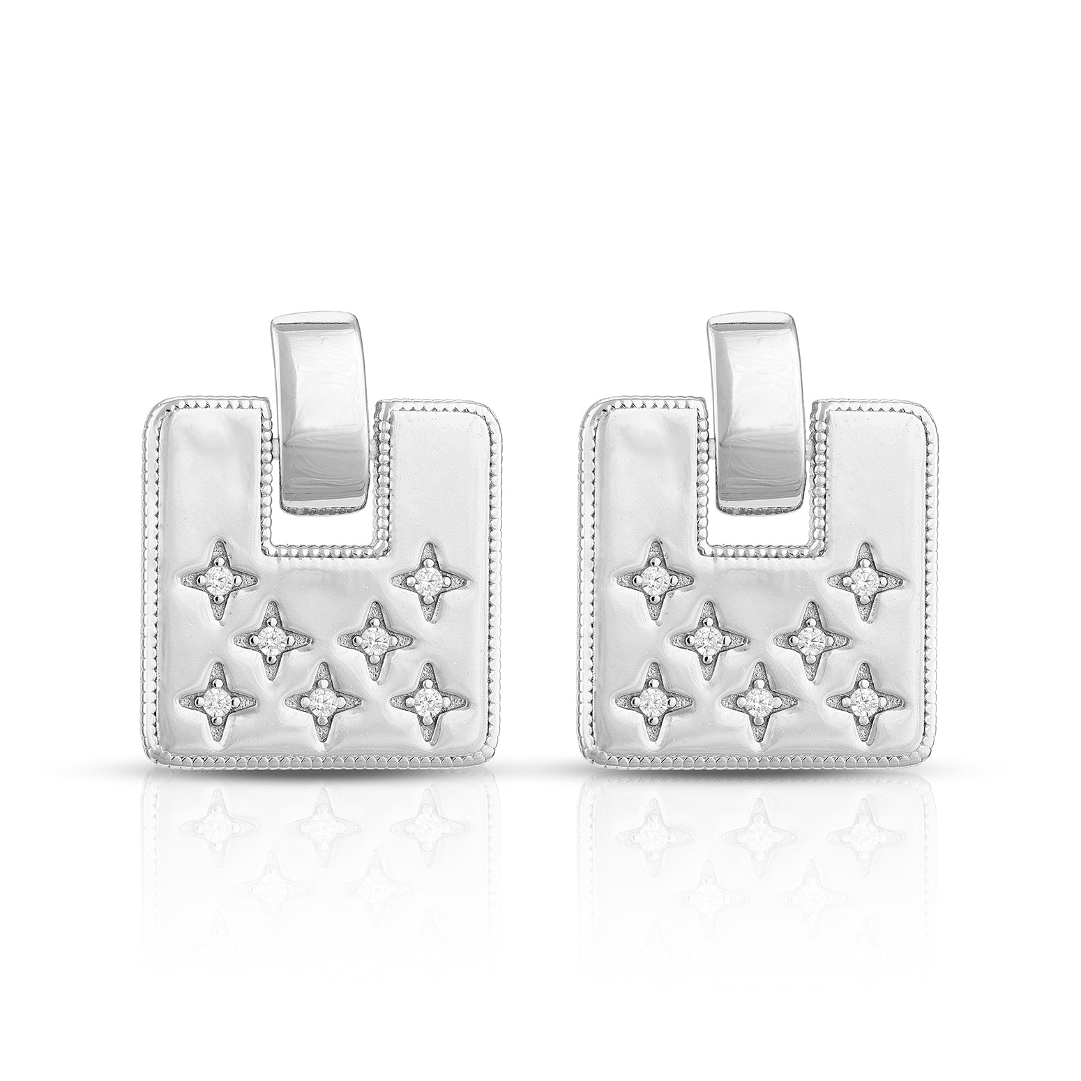 Pair of silver earrings with star designs on a white background