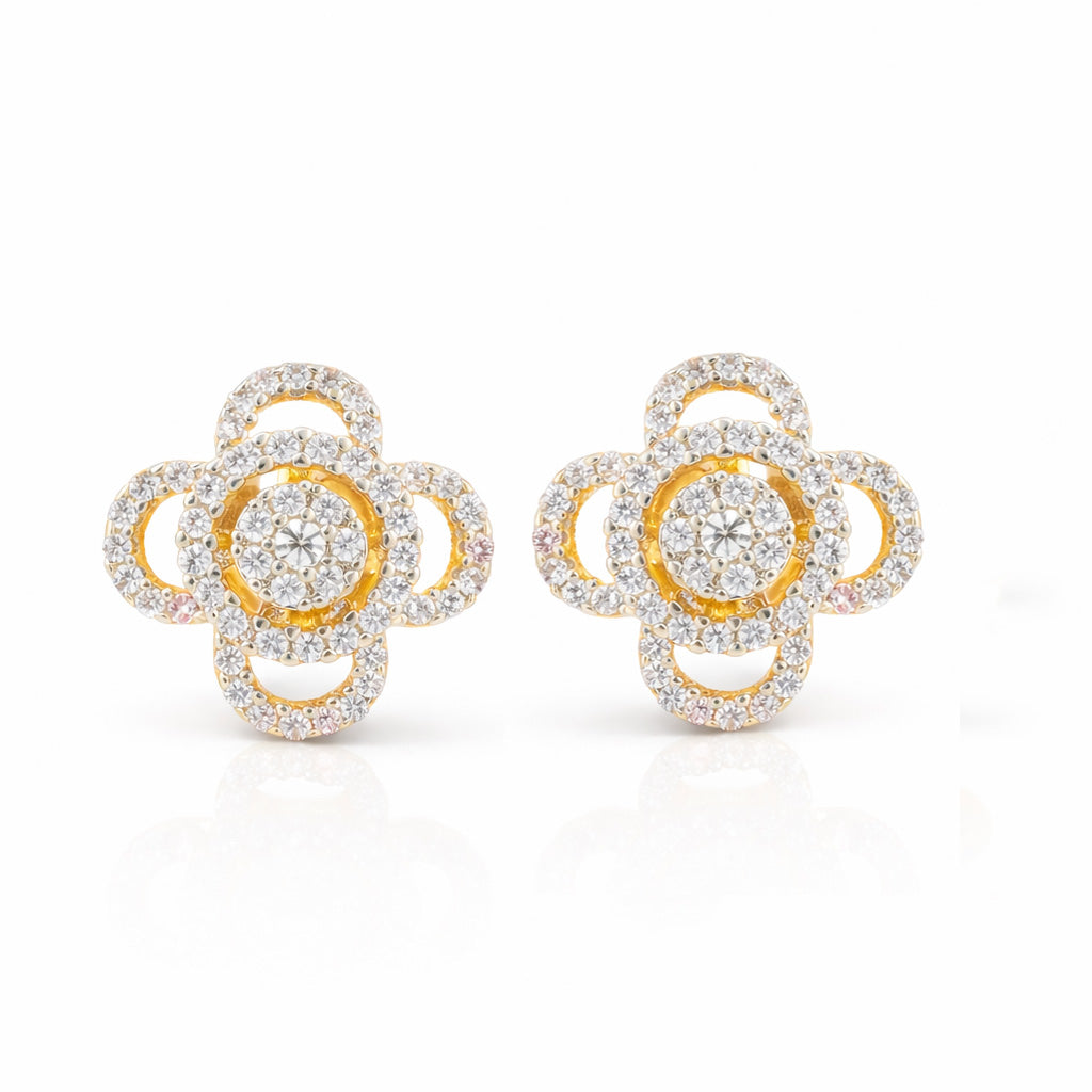 Gold and diamond flower-shaped earrings on a white background