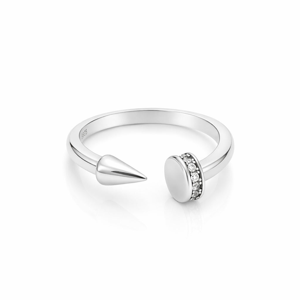 Silver ring with a spike and round gemstone on a white background