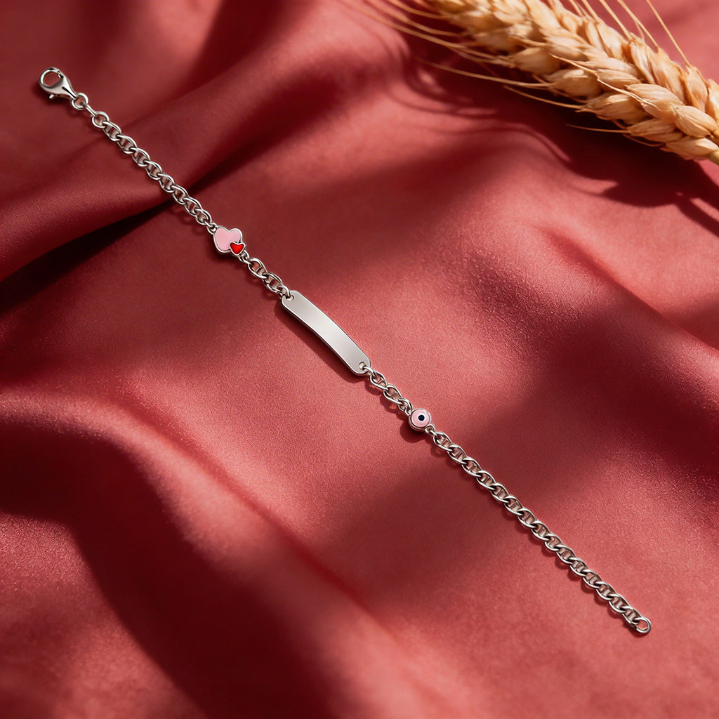 Silver bracelet with heart and star charms on a red fabric background