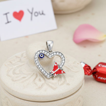 Heart-shaped pendant with butterfly design on a decorative stone surface with &