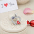 Heart-shaped pendant with butterfly design on a decorative stone surface with &