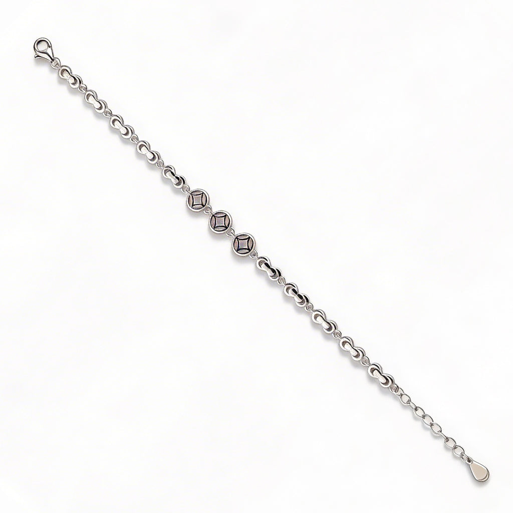 Silver bracelet with diamond-like beads on a white background