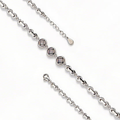 Silver chain with diamond-like beads on a white background