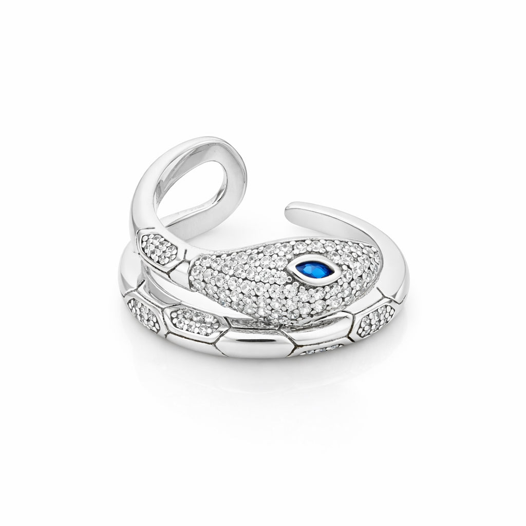 Silver peacock feather charm with a blue gemstone on a white background