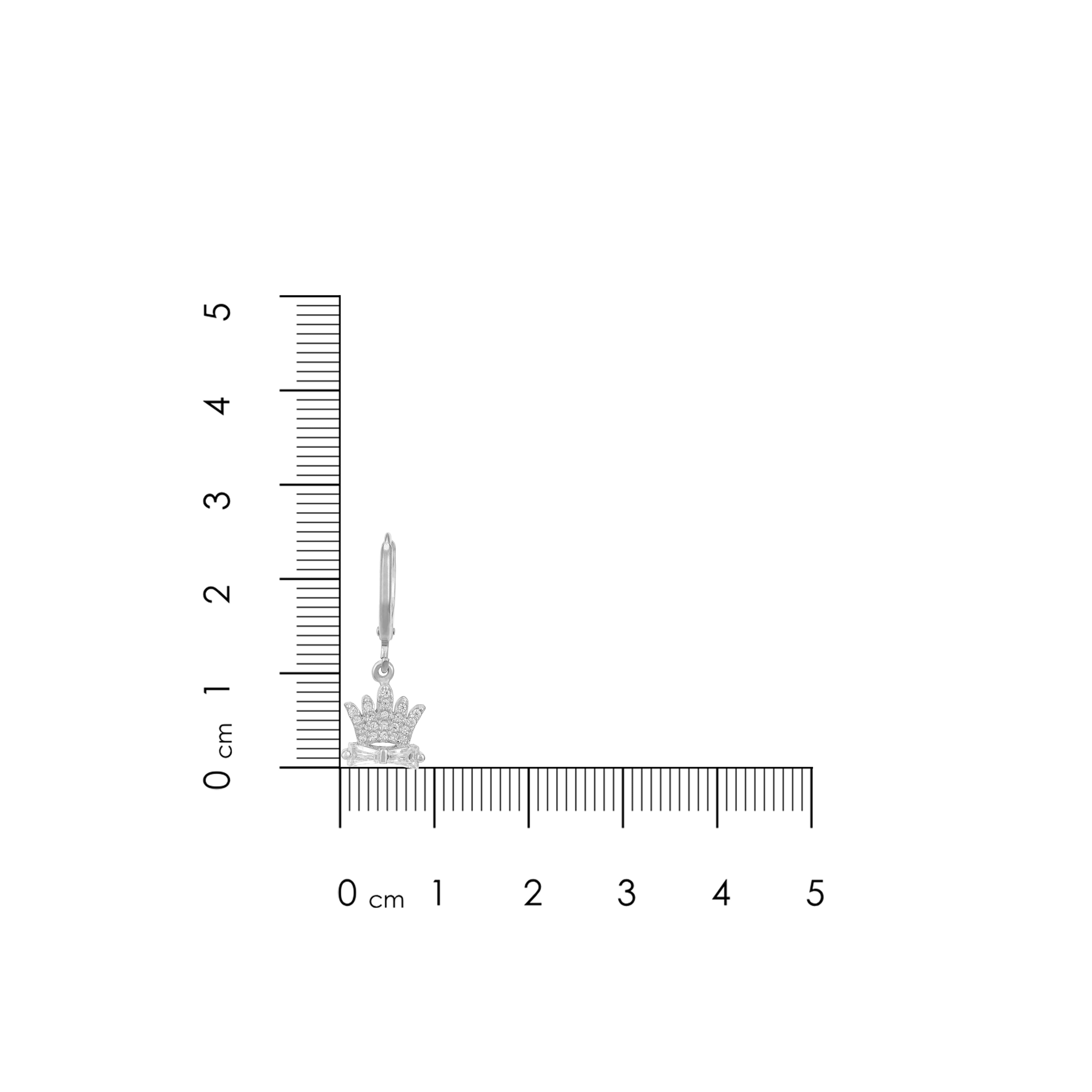 Silver earring with crown design next to a ruler for scale on a white background