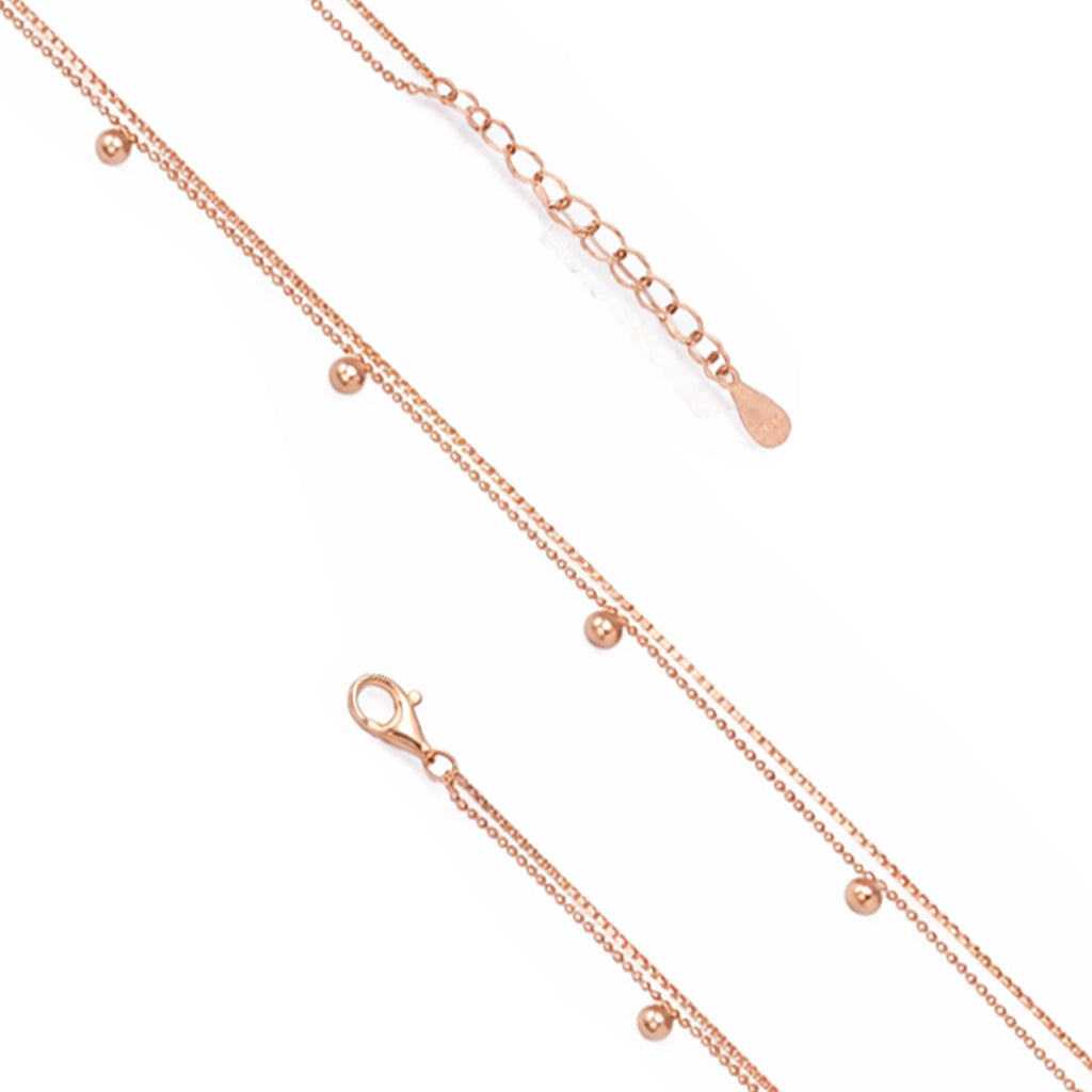 Rose gold necklace with small beads on a white background