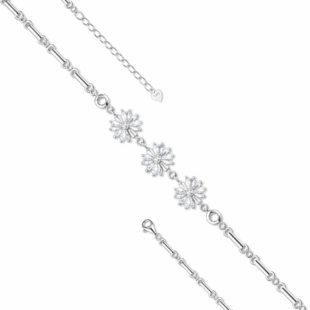 Silver bracelet with snowflake designs on a white background