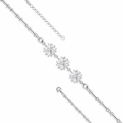 Silver bracelet with snowflake designs on a white background