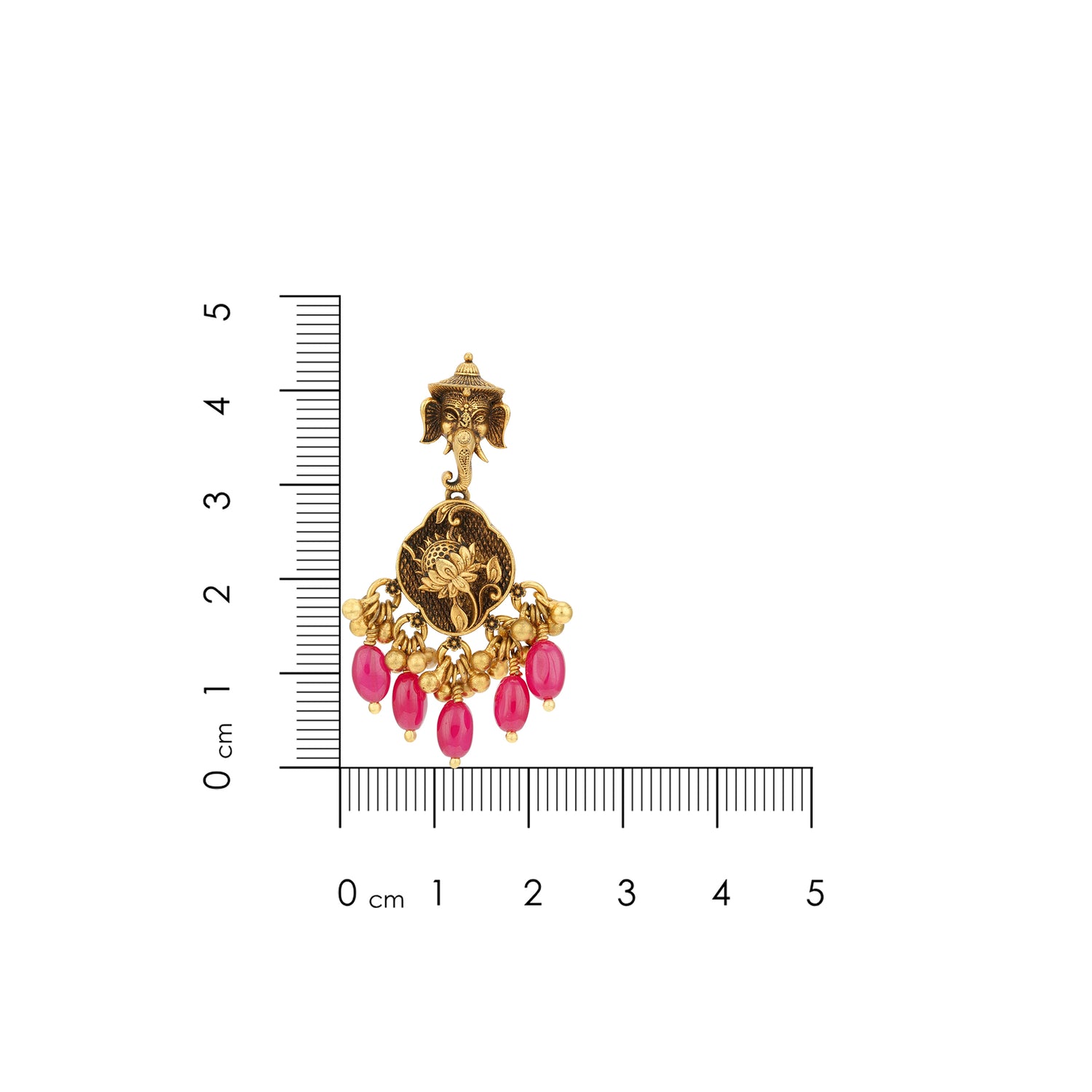 Gold earring with pink stones next to a ruler for scale on a white background