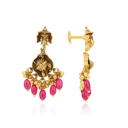 Gold earrings with pink beads on a white background