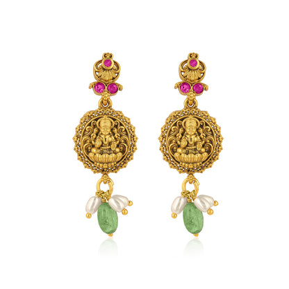 Gold earrings with religious figure, pink gemstones, and green beads on a white background