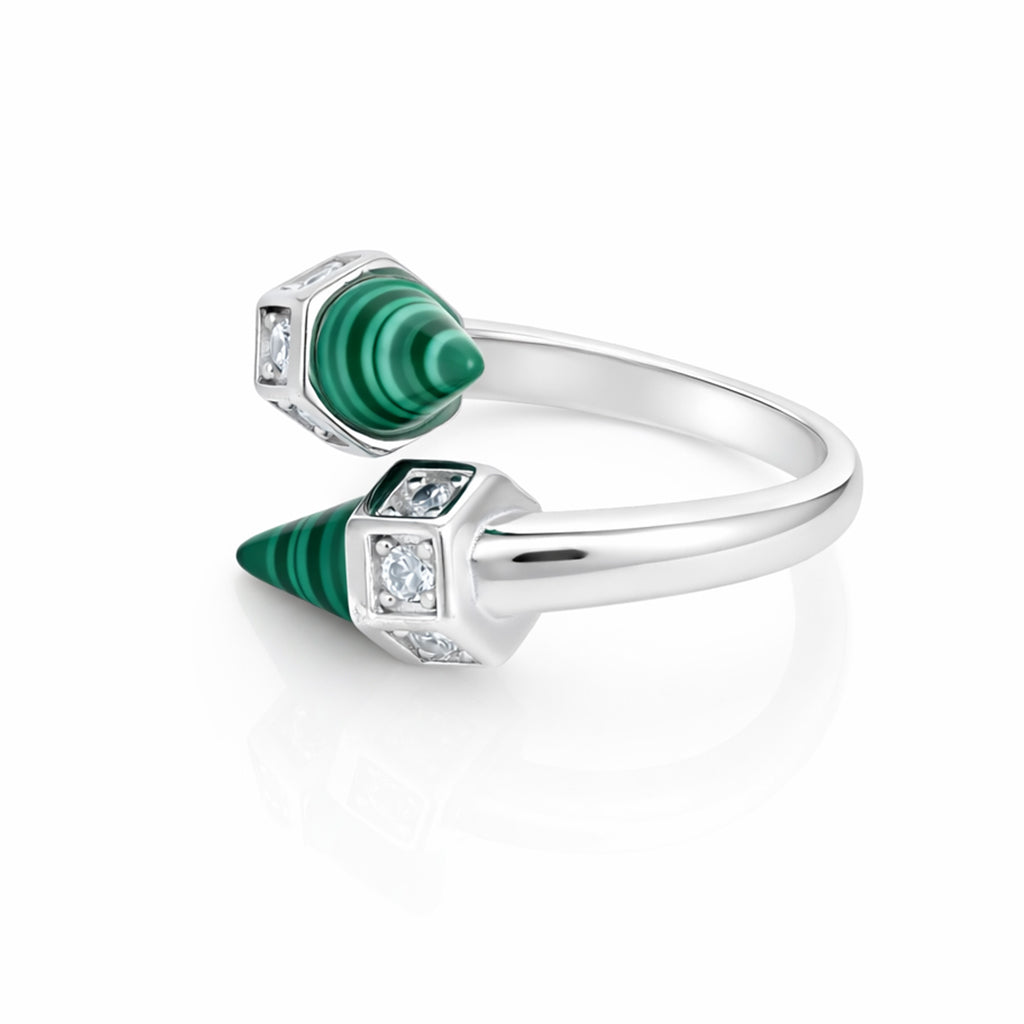Silver ring with green gemstones and diamonds on a white background