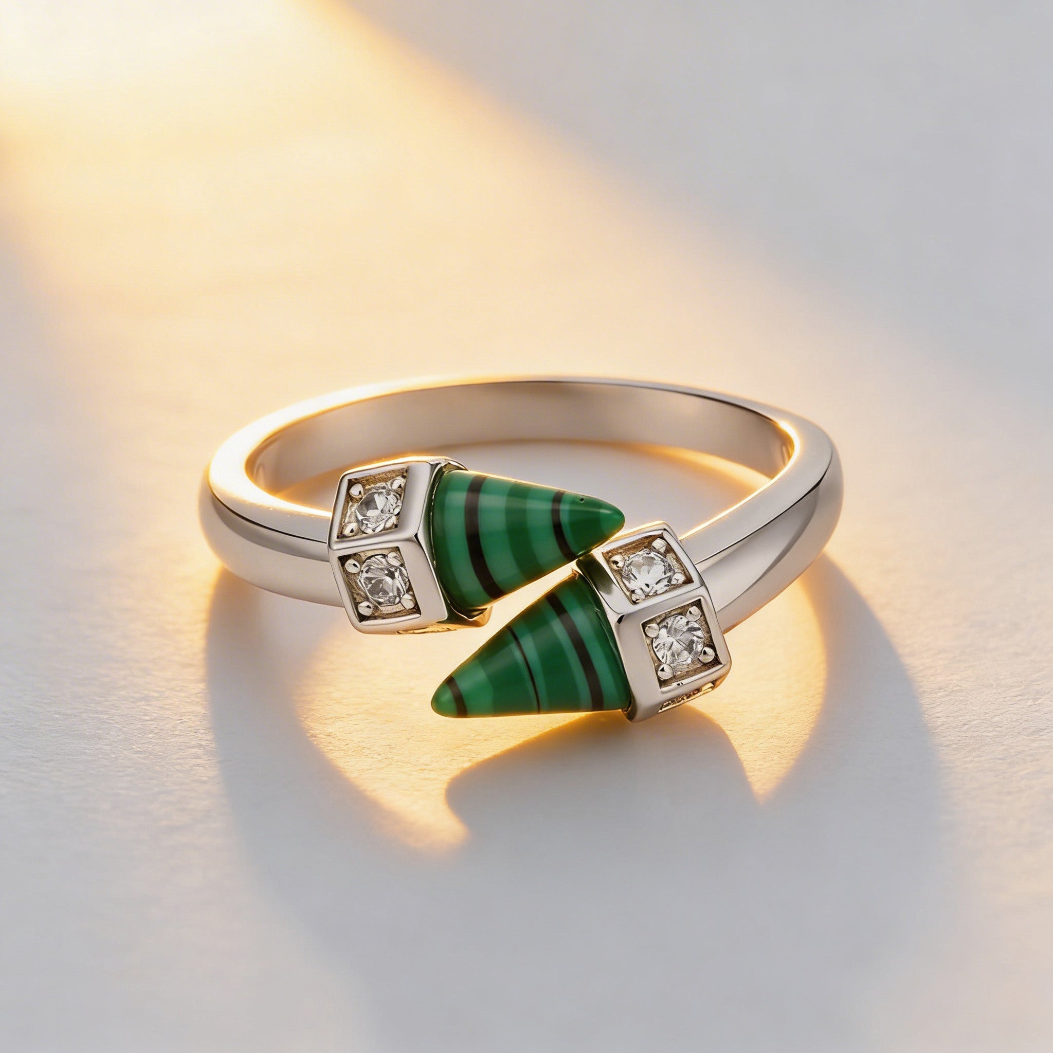 Gold ring with green gemstone and diamonds on a light background