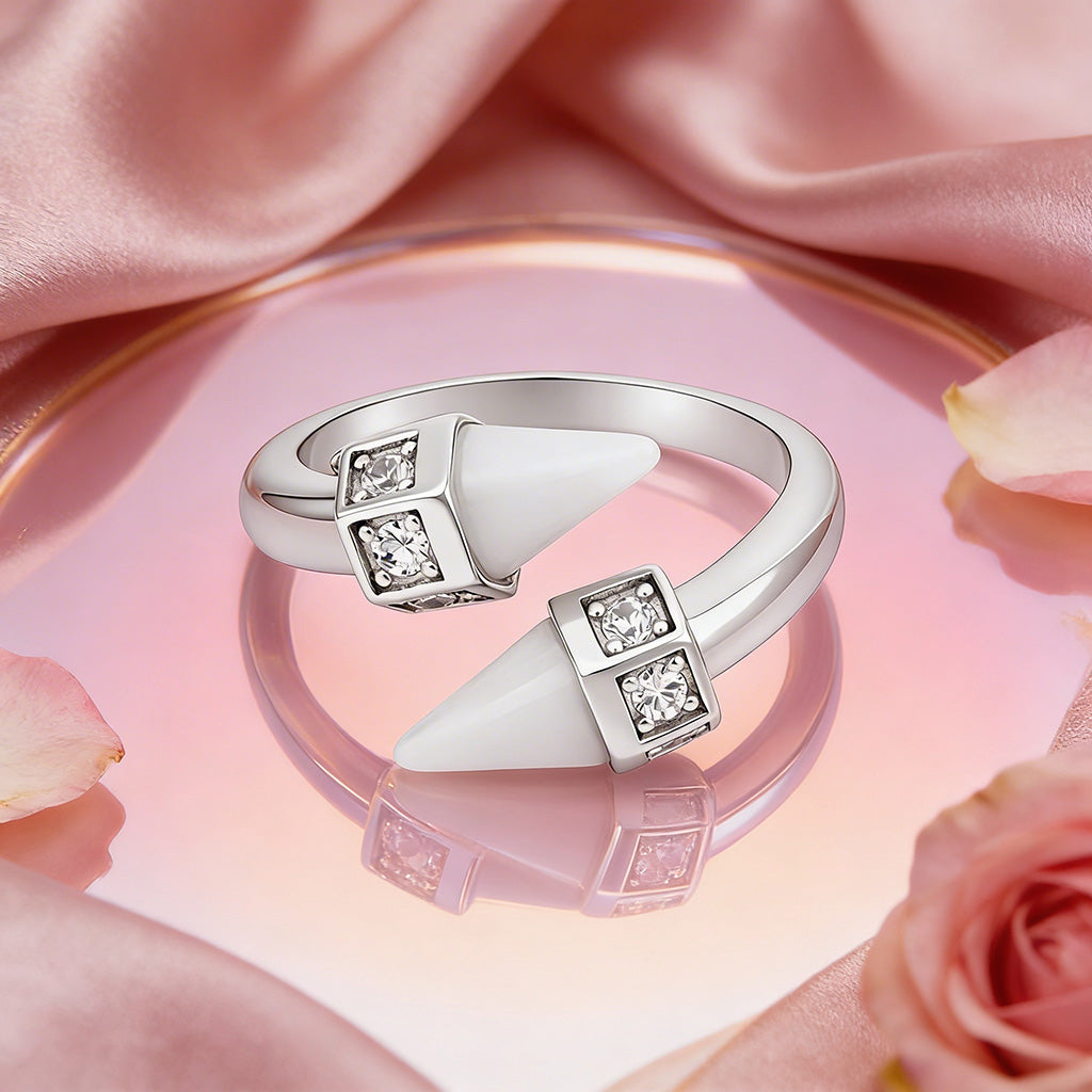 Silver ring with gemstones on a pink fabric background