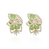 Pair of earrings with green gemstones and gold accents on a white background