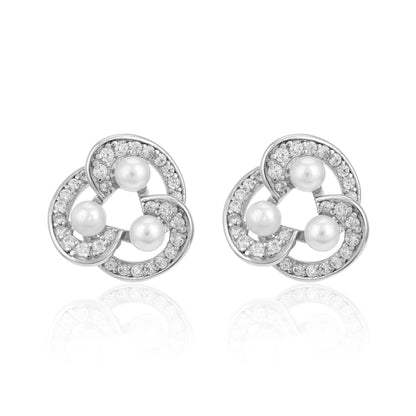 Pair of silver earrings with pearls and clear stones on a white background