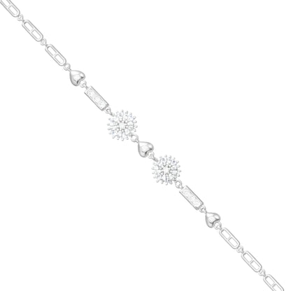 Silver bracelet with heart and snowflake charms on a white background