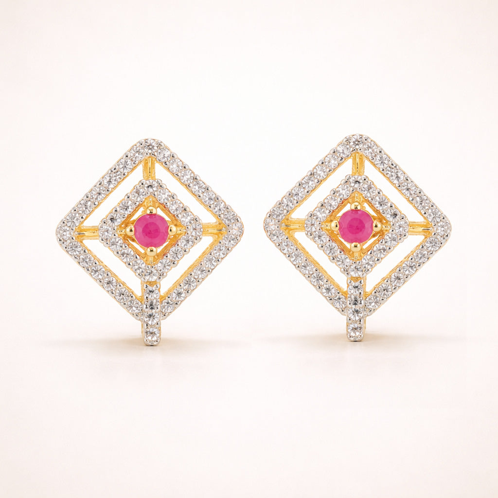 Pair of diamond-shaped earrings with pink gemstones on a white background