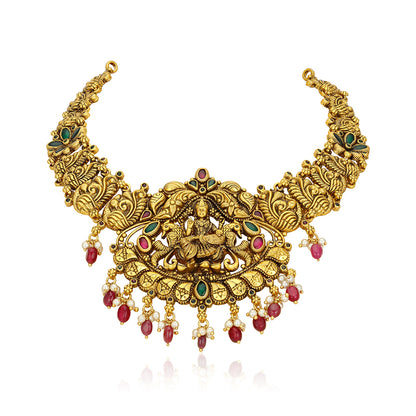Ornate gold necklace with red and green gemstones on a white background