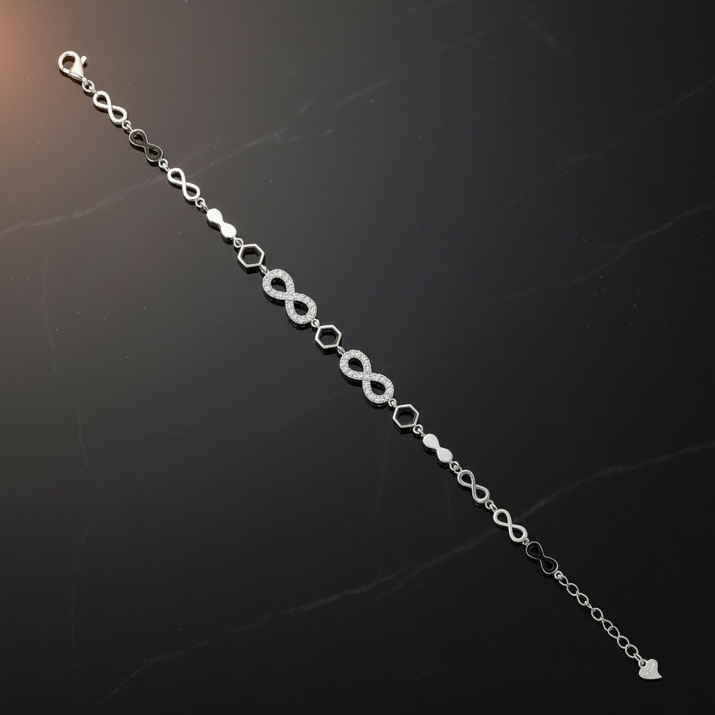 Silver bracelet with infinity symbol on a dark textured background
