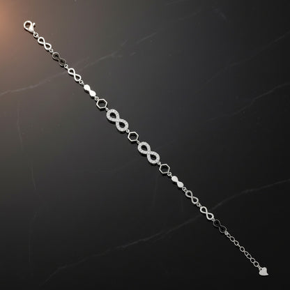 Silver bracelet with infinity symbol on a dark textured background