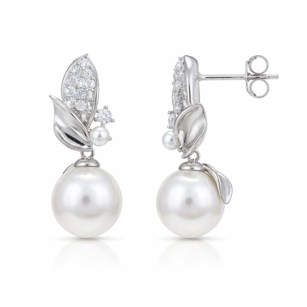 Pearl earrings with silver leaf designs on a white background