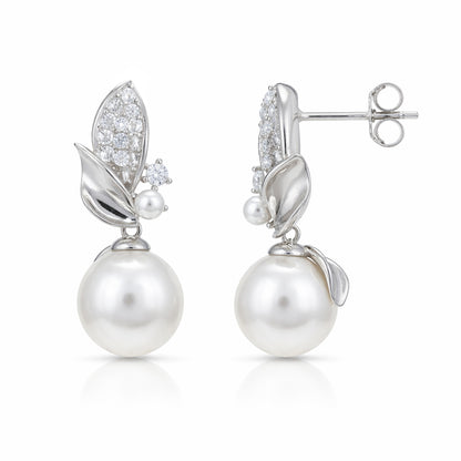 Pearl earrings with silver leaf designs on a white background