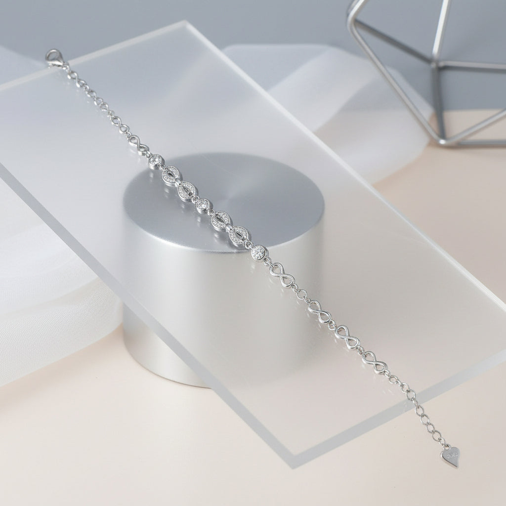 Silver bracelet on a clear stand with a neutral background