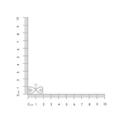 Small diamond ring on a ruler for scale on a white background