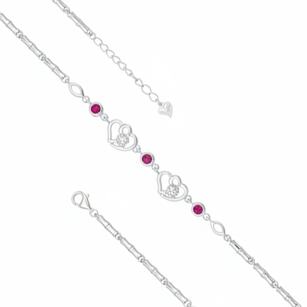 Silver bracelet with heart and gemstone charms on a white background