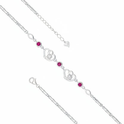 Silver bracelet with heart and gemstone charms on a white background