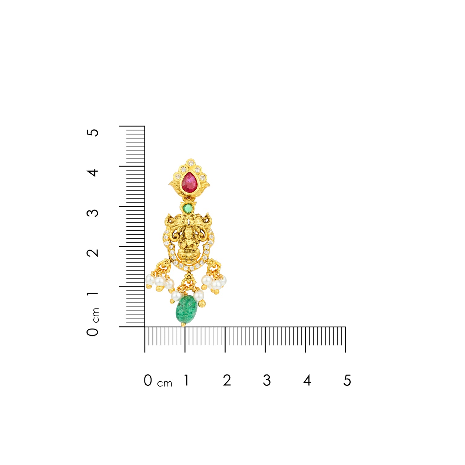 Gold earring with gemstones next to a ruler for scale on a white background