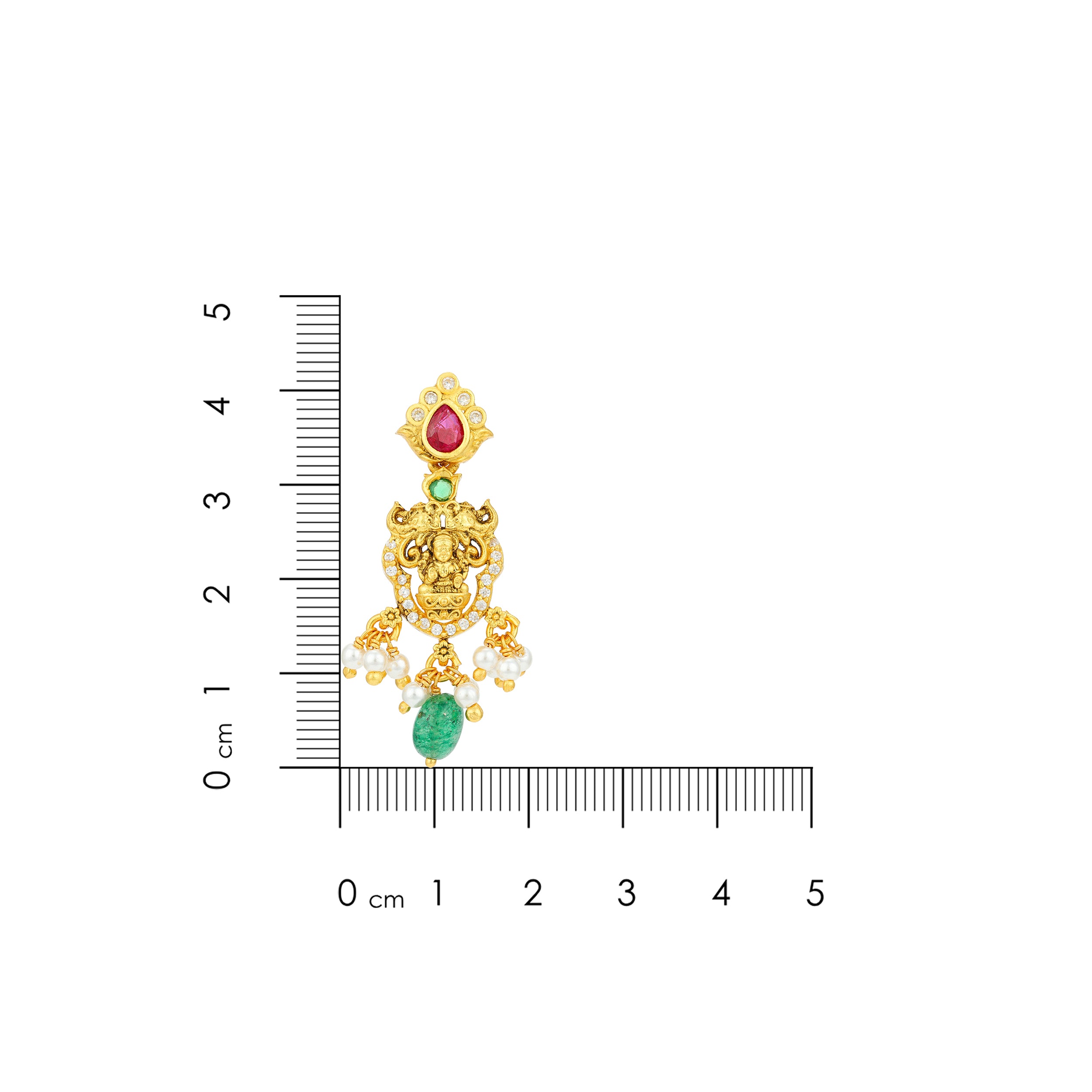 Gold earring with gemstones next to a ruler for scale on a white background