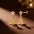 Gold earrings with diamond accents on a brown surface