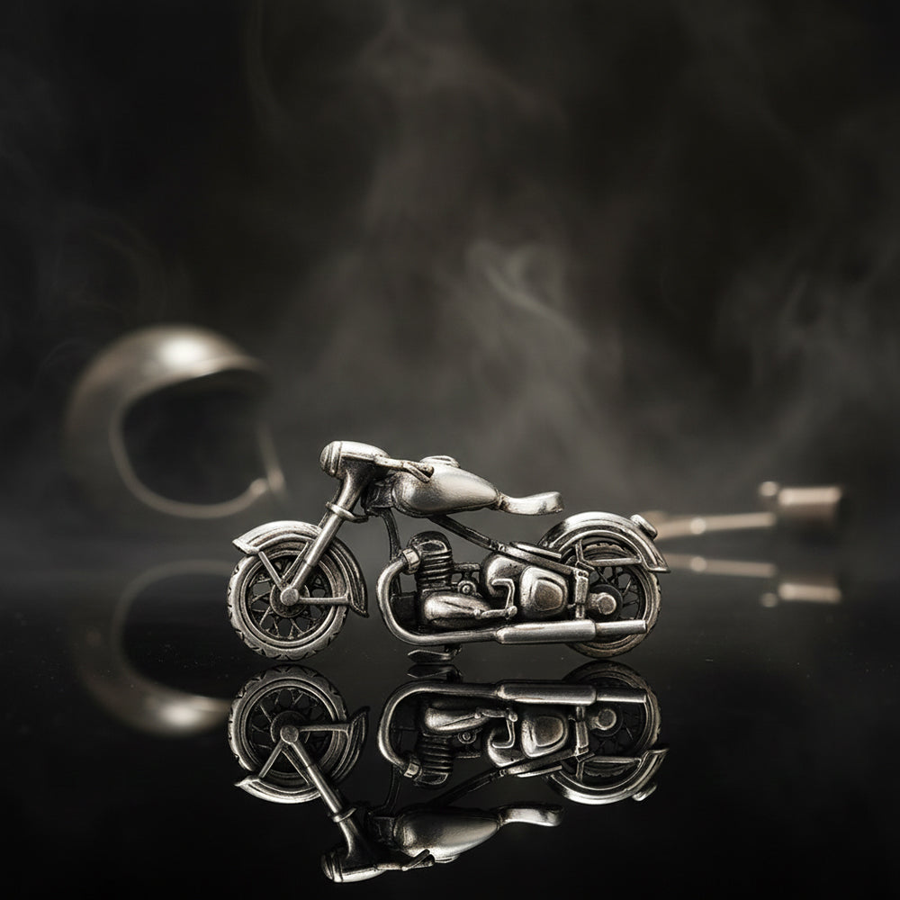 Metallic motorcycle model on a reflective surface with dark background