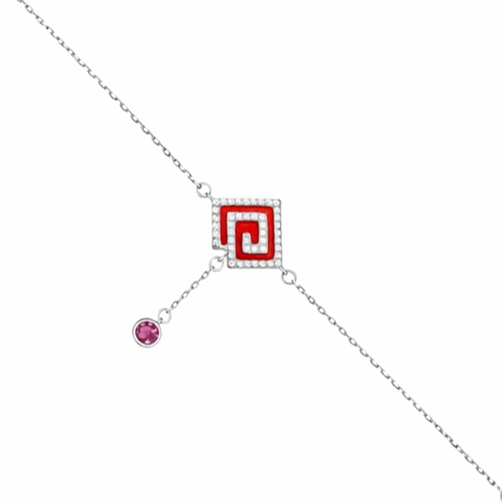 Silver bracelet with a red square charm and pink gemstone on a white background