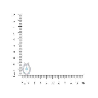 Diamond ring with a blue gemstone on a ruler for scale