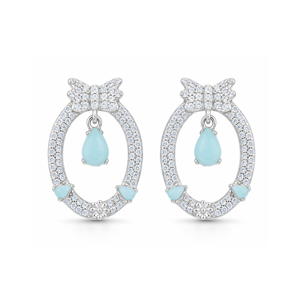 Pair of earrings with butterfly designs and light blue teardrop stones on a white background