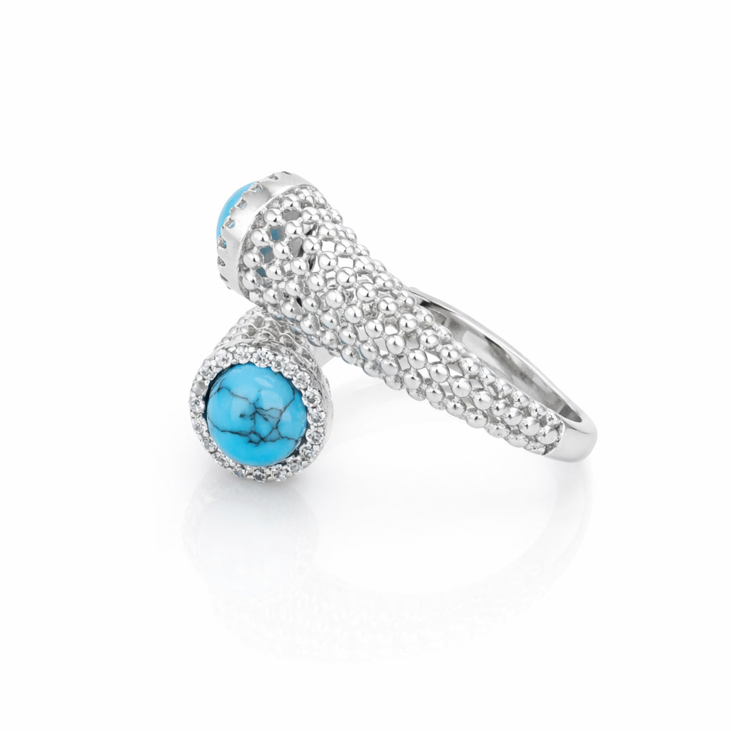 Silver ring with a turquoise gemstone on a white background